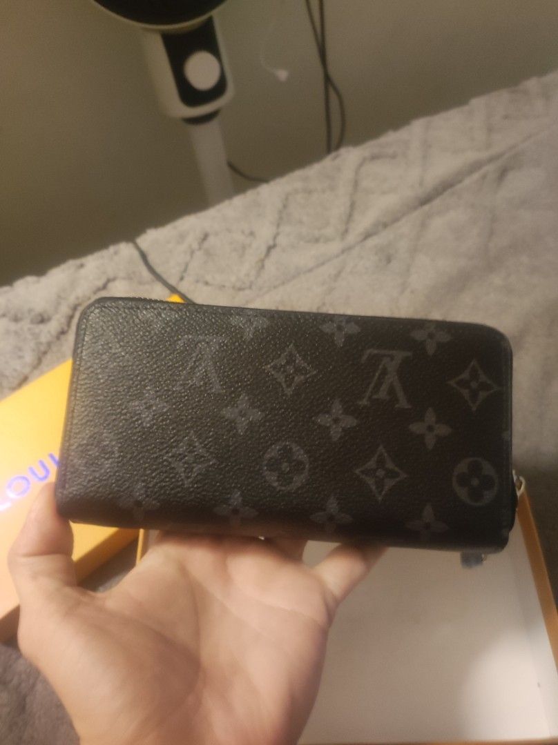 Louis Vuitton Monogram Eclipse Zipper Wallet with Box (Category: Luxury Bags & Wallets) located in Pasay City. Submitted by wizemindz138970 (Listing ID 1466476434, Image 2). Description: - Authentic Black Monogram Eclipse canvas wallet - Dual zip compartments and multiple interior card slots - Clean interior with pristine silver-tone hardware zippers - Includes protective foam inserts - Comes with original orange branded storage box and attached 