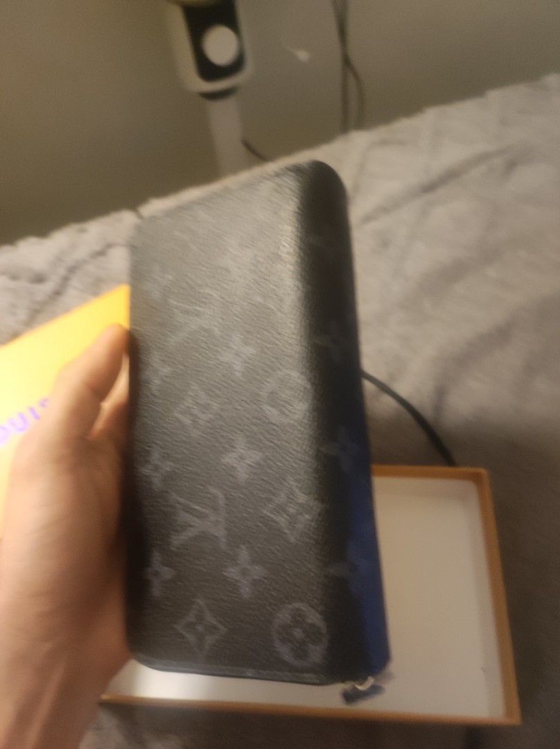 Louis Vuitton Monogram Eclipse Zipper Wallet with Box (Category: Luxury Bags & Wallets) located in Pasay City. Submitted by wizemindz138970 (Listing ID 1466476434, Image 3). Description: - Authentic Black Monogram Eclipse canvas wallet - Dual zip compartments and multiple interior card slots - Clean interior with pristine silver-tone hardware zippers - Includes protective foam inserts - Comes with original orange branded storage box and attached 