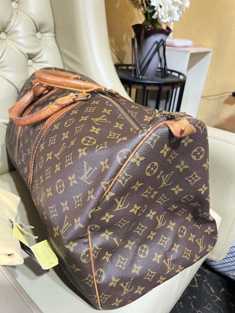 Louis Vuitton Monogram Keepall Duffle Bag (Category: Luxury Bags & Wallets) located in Manila. Submitted by keencrystal.595c28 (Listing ID 1466523179, Image 3). Description: - Authentic Louis Vuitton Monogram travel bag - Classic brown canvas with tan leather handles and trim - Durable brass hardware with secure top zip closure - Clean brown textile interior lining - Includes original luggage tag and dust bag.