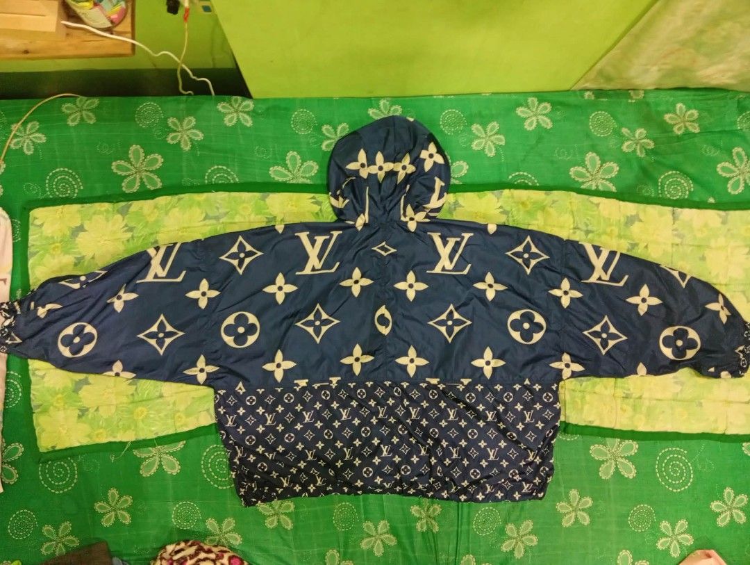 Louis Vuitton Monogram Windbreaker Blue (Category: Luxury Apparel) located in Manila. Submitted by rms.thrift (Listing ID 1466454676, Image 2). Description: - Brand: Louis Vuitton - Item: Monogram Windbreaker Jacket - Color: Navy blue with iconic monogram and flower print - Size: 34 (label near collar) - Features: Hooded with white drawstrings and branded metal stoppers, full front zip closure, two patterned front pockets - Origin: Made in Italy 