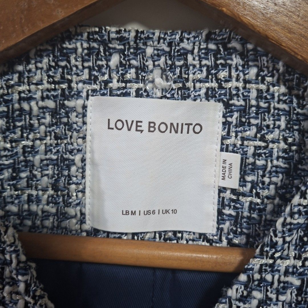 Love Bonito Tweed Jacket Blue White Size M (Category: Coats, Jackets and Outerwear) located in Quezon City. Submitted by arargarcia (Listing ID 1466456130, Image 2). Description: - Brand: Love Bonito - Style: Classic structured tweed jacket - Color: Blue and white with shiny metallic threads - Details: Gold-tone hammered buttons on sleeve cuffs, fully lined - Size: Medium (US 6, UK 10) - Origin: Made in China - Condition: Great for elevating both