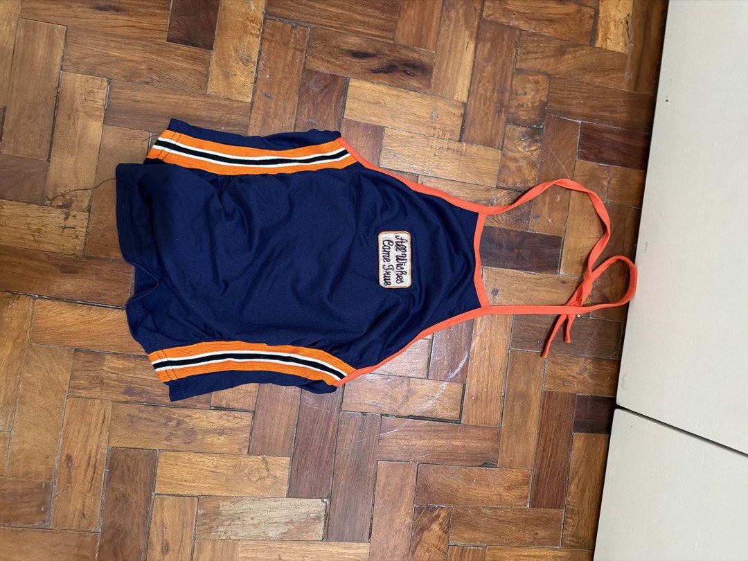 Lovito Navy Blue Halter Top Size XS (Category: Sleeveless) located in Manila. Submitted by wearagainfinds (Listing ID 1466417036, Image 1). Description: - Brand: Lovito - Size: XS (EU 32, US 2) - Color/Design: Navy blue with bright orange trim, black and white side stripes, and a script text chest patch - Style: Halter neck with tie-back straps - Origin: Made in China (fabric tag attached).