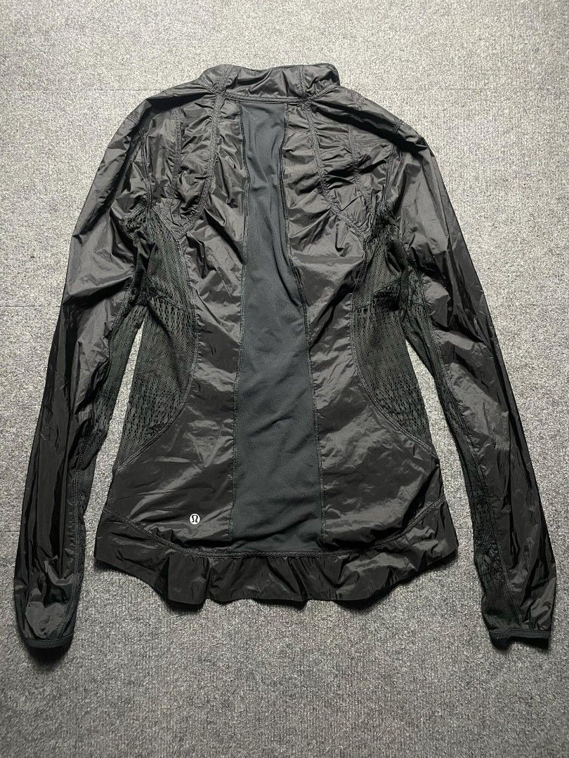 Lululemon Black Athletic Zip Jacket (Category: Activewear) located in Ligao. Submitted by merjudioma64633 (Listing ID 1466386865, Image 2). Description: - Brand: Lululemon - Color: Black - Style: Full-zip athletic jacket / lightweight windbreaker - Breathability: Mesh panels on sides and back - Features: High collar, long sleeves with ribbed cuffs, iconic logo near back hem - Condition: Excellent - Perfect for: Running, workouts, and casual wear.