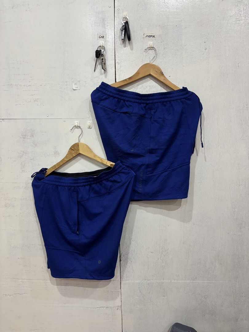 Lululemon Blue Athletic Shorts With Zipper Pockets (Category: Activewear) located in Manila. Submitted by noribrahim.20 (Listing ID 1466363531, Image 3). Description: - Brand: Lululemon - Color: Bright Blue - Material: Lightweight textured fabric - Waistband: Elastic with interior adjustable drawstrings - Pockets: Secure zippered pockets on side and back - Details: Small reflective logo near hem - Ideal for: Workouts, running, and casual wear.
