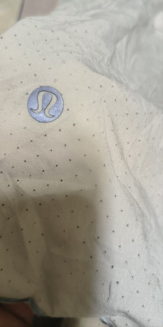Lululemon Men's Athletic Shorts Size S (Category: Shorts) located in Manila. Submitted by itsmelawrence (Listing ID 1466357546, Image 3). Description: - Brand: Lululemon - Item: Men's Athletic Shorts - Size: S 26+ x 13 - Color: Light Grey - Material: Perforated fabric for maximum breathability - Features: Elastic waistband with adjustable drawstring, iconic silver reflective logo on lower hem - Condition: Excellent, great for running or gym sessi