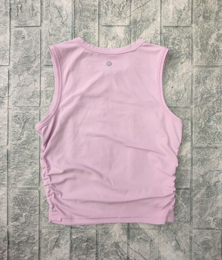 lululemon Tank Top (Category: Sleeveless) located in Bayambang. Submitted by mon10192816 (Listing ID 1466466091, Image 2). Description: - Width 15¾ - Length 18 - Brand: Lululemon - Style: Crew neckline, sleeveless, ruched side details for a flattering shape - Logo: Silver reflective logo on upper back - Fabric: Soft, high-performance athletic material - Versatility: Great for workouts, gym sessions, or daily casual wear - Pairing: Easy to style w