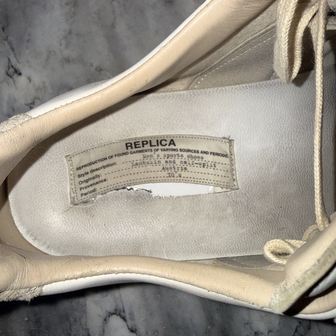 Maison Margiela Replica Sneakers Size 44 (Category: Casual Shoes) located in Daraga. Submitted by sudeboy031092 (Listing ID 1466506048, Image 2). Description: - Brand/Model: Maison Margiela Replica GAT Sneakers - Colorway: White leather with grey suede overlays and classic gum sole - Size: EU 44 (Made in Italy) - Authentic Details: Size stamp on inner tongue and iconic numbered text patch with intentional tearing on the footbed - Condition: Norma