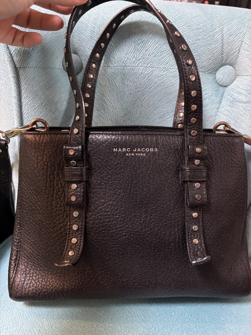 Marc Jacob leather Bag (Category: Cross-body Bags) located in Pasig City. Submitted by karlstine19 (Listing ID 1466474891, Image 1). Description: Details: * Brand: Marc Jacobs * Model: Mini T Tote / Studded Handle Tote * Style code: M0011998 001 * Color: Black * Material: Leather * Distinctive feature: Studded leather handles * Approx. size: 25.5 cm wide × 6.5 cm deep in one listing Issue: Lost Stud please see the last pic. Price is Negotiable RF