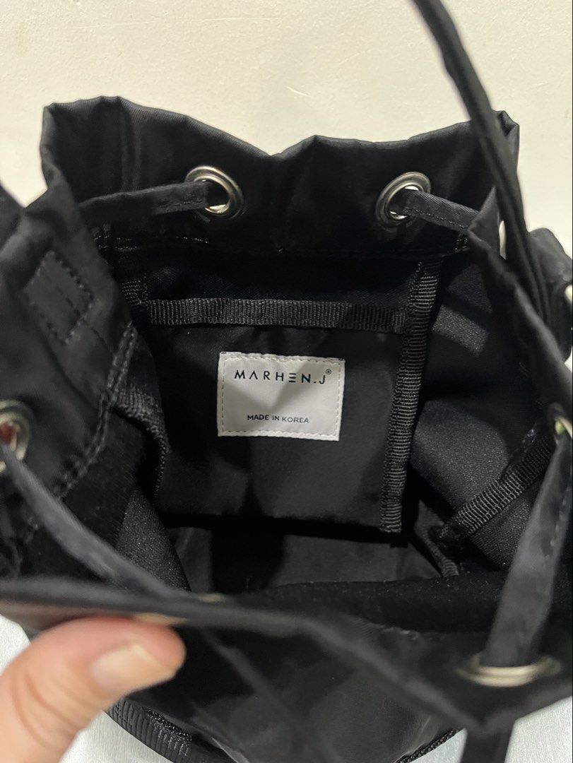 Marhen.J Black Nylon Bucket Bag with Strap (Category: Shoulder Bags) located in Talisay. Submitted by cherylu (Listing ID 1466561602, Image 3). Description: - Brand: Marhen.J - Color: Black - Material: Durable nylon with silver hardware - Closure: Drawstring top - Design: Bold white brand logo on front - Strap: Black shoulder strap with repeating logo text and metal aglets - Interior: Fabric-lined with an internal pocket patch and 'Made in Korea'