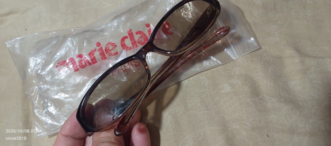 Marie Claire Paris MAR5003 C64 Eyeglasses Frames (Category: Sunglasses & Eyewear) located in Quezon City. Submitted by sellingwithlove2018 (Listing ID 1466561528, Image 2). Description: - Brand/Model: Marie Claire Paris MAR5003 C64 - Size: 56-15-130 - Design: Dark brown and translucent gradient frame - Lenses: Original tinted/shaded style - Inclusions: Branded plastic storage sleeve - Details: Clear model number and branding prints on temple arms