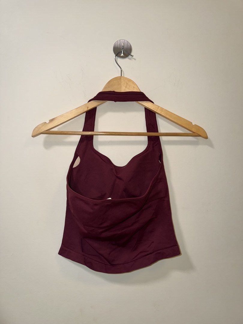 Maroon Halter Neck Activewear Tank Top Size S (Category: Sleeveless) located in Makati City. Submitted by andzr. (Listing ID 1466481274, Image 2). Description: - Color: Maroon - Size: Small - Material: 90% Polyamide, 10% Elastane (super stretchy & comfortable) - Style: Halter neck crop top with ribbed texture and built-in support - Condition: Brand new with tags attached, clean inside and out - Ideal for: Workouts or casual everyday wear.
