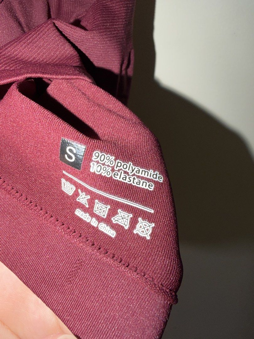 Maroon Halter Neck Activewear Tank Top Size S (Category: Sleeveless) located in Makati City. Submitted by andzr. (Listing ID 1466481274, Image 3). Description: - Color: Maroon - Size: Small - Material: 90% Polyamide, 10% Elastane (super stretchy & comfortable) - Style: Halter neck crop top with ribbed texture and built-in support - Condition: Brand new with tags attached, clean inside and out - Ideal for: Workouts or casual everyday wear.
