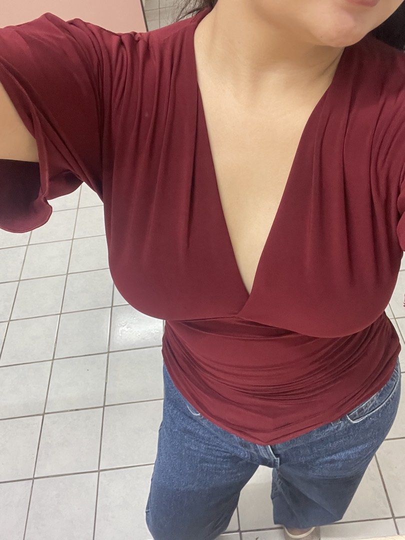 maroon v-neck wrap top (Category: Blouses) located in Pateros City. Submitted by jiannaross (Listing ID 1466476804, Image 2). Description: - Color: Rich maroon - Style: Deep V-neck, surplice wrap with short sleeves - Material: Super stretchy fabric with soft chest draping - Versatility: Pairs easily with blue jeans or skirts - Condition: Worn a couple of times, still in great shape.