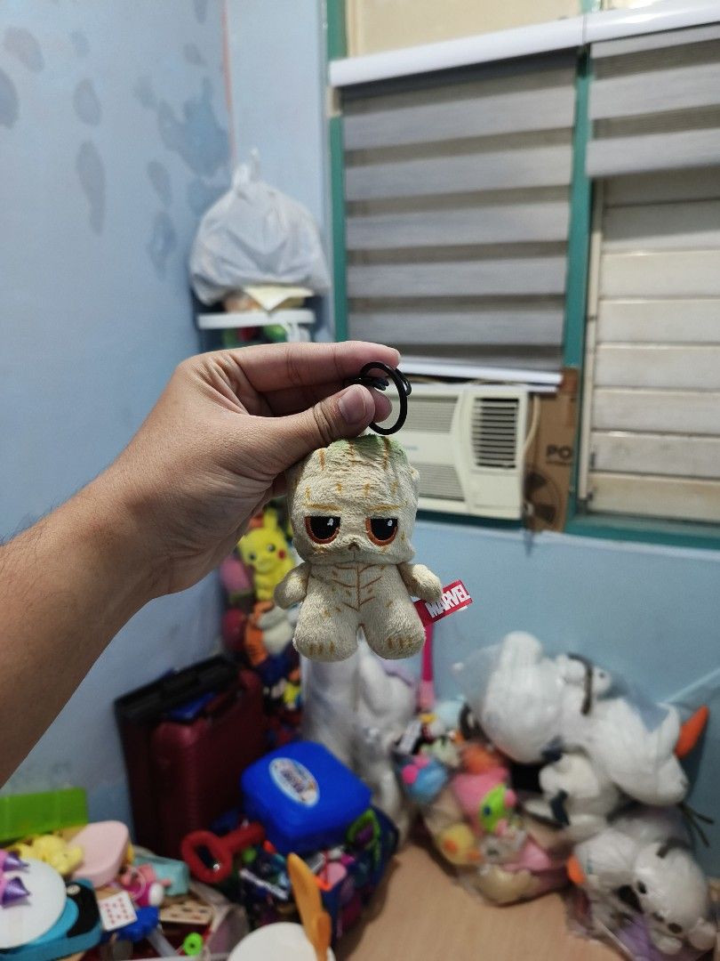 Marvel Groot Plush Keychain (Category: Plushies & Soft Toys) located in Iligan City. Submitted by sneakymagician (Listing ID 1466479396, Image 1). Description: - Official Marvel Mini Groot plush charm - Features detailed embroidery and textured fabric - Equipped with a black plastic clip ring for easy hanging - Includes authentic red Marvel side tag - Perfect cute accessory for bags, backpacks, or keys.