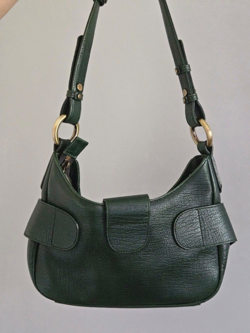 MCM Dark Green Leather Shoulder Bag (Category: Luxury Bags & Wallets) located in Manila. Submitted by missyyyxx (Listing ID 1466452552, Image 3). Description: - Brand: MCM (RARE, HARD TO FIND! 😍) - Material: Premium dark green pebbled leather - Hardware: Gold-tone with signature front logo plate - Closure: Top zipper closure - Interior: Fabric-lined with a convenient inner zip pocket - Strap: Adjustable strap with brass rings and studs - Conditi
