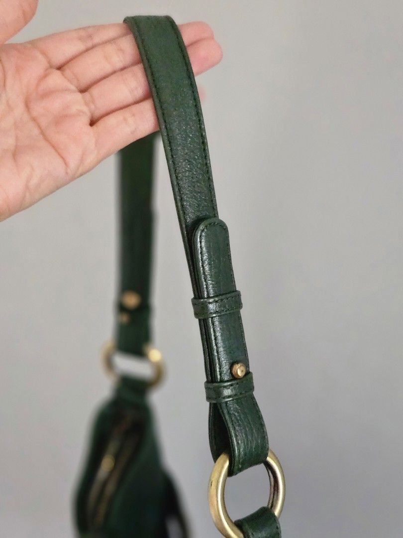 MCM Dark Green Leather Shoulder Bag (Category: Luxury Bags & Wallets) located in Manila. Submitted by missyyyxx (Listing ID 1466452552, Image 2). Description: - Brand: MCM (RARE, HARD TO FIND! 😍) - Material: Premium dark green pebbled leather - Hardware: Gold-tone with signature front logo plate - Closure: Top zipper closure - Interior: Fabric-lined with a convenient inner zip pocket - Strap: Adjustable strap with brass rings and studs - Conditi