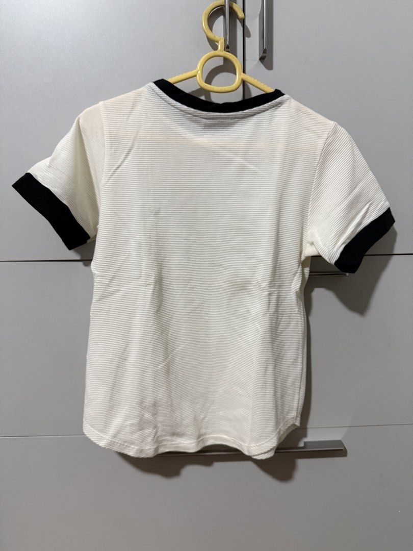 MEMO Ultimate Basics Ringer T-Shirt White Black (Category: Shirts) located in Manila. Submitted by mpt99876 (Listing ID 1466523397, Image 3). Description: - Brand: MEMO Ultimate Basics - Color: White with black collar and sleeve trim - Size: XS - Material: Textured ribbed fabric - Design: Small embroidered eye logo on the left chest, crew neck, short sleeves, curved hem - Style: Simple everyday basic, easy to match with jeans or shorts.