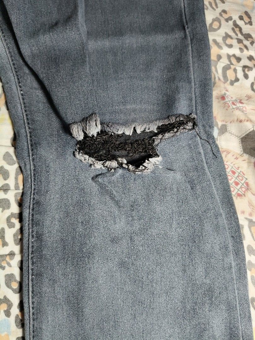 Men's Distressed Slim-Fit Jeans (Category: Jeans) located in Lapu Lapu. Submitted by hooman422 (Listing ID 1466562558, Image 2). Description: • Product: Distressed denim jeans • Color: Grayish dark blue wash • Style: Regular/slim straight-leg fit • Distress details: Prominent horizontal cut-outs/slits at both knees with frayed edges • Design elements: Classic five-pocket configuration, standard belt loops, and center button closure with front zip