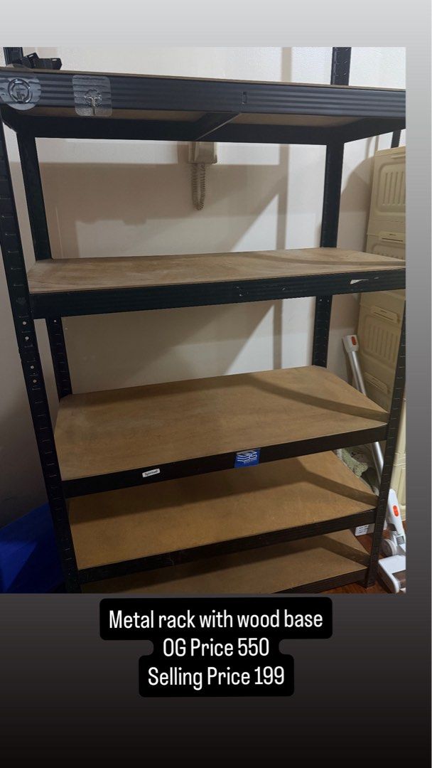 Metal rack with wood base storage shelf (Category: Shelves, Cabinets & Racks) located in Manila. Submitted by gklzg (Listing ID 1466360720, Image 1). Description: - Sturdy metal and wood rack - Heavy-duty black steel frame with brown wooden shelves - Multi-tier design ideal for storage rooms, offices, or living spaces - Original price: ₱550 - Clearance price: ₱199 only.