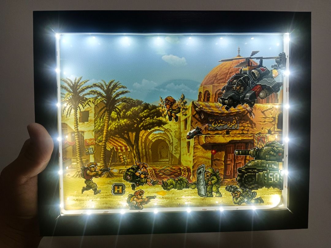 Metal Slug Retro Video Game Shadow Box (Category: Nintendo) located in Quezon City. Submitted by natzuki10 (Listing ID 1466369953, Image 2). Description: Metal Slug Retro Video Game Shadow Box Height: 8 inches Width: 10 inches 750 w/o lights 920 w/ lights *Handmade Pixel Shadow Boxes *Accepting Customized Designs *Perfect for Gamers & Collectors #videogames #roomdecor #collection #gamer #gift .