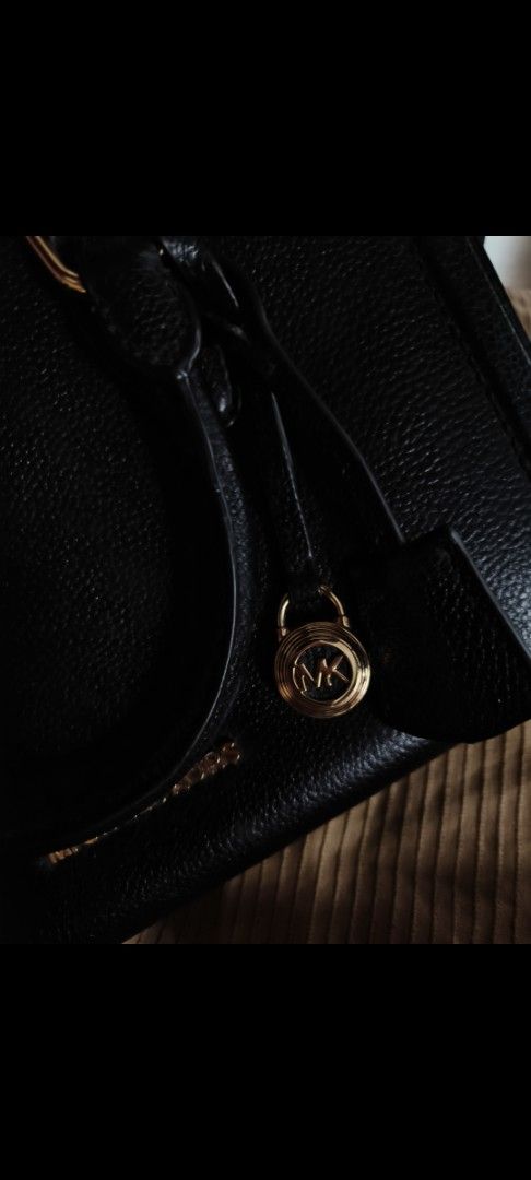 Michael Kors Black Leather Satchel Handbag (Category: Luxury Bags & Wallets) located in Baguio. Submitted by daniel_c27 (Listing ID 1466529677, Image 2). Description: - Brand: Michael Kors - Material: Premium black pebble leather - Hardware: Elegant gold-tone with metal lettering logo - Closure: Secure top zipper closure - Straps: Dual top handles and a detachable/adjustable shoulder strap - Extras: Iconic hanging circular MK logo charm - Conditi