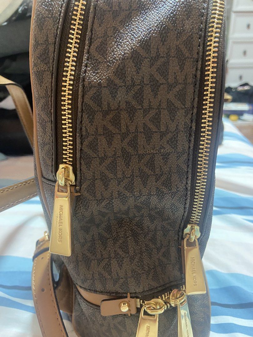 Michael Kors Brown Monogram Backpack (Category: Backpacks) located in Las Pinas. Submitted by 22nellie28 (Listing ID 1466552575, Image 3). Description: - Authentic Michael Kors signature MK monogram in classic brown - Elegant gold-tone hardware and secure zipper closures - Convenient front zip pocket and sturdy top handle - Spacious interior designed to fit your daily essentials.