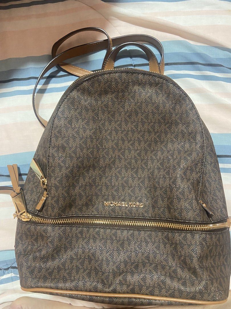 Michael Kors Brown Monogram Backpack (Category: Backpacks) located in Las Pinas. Submitted by 22nellie28 (Listing ID 1466552575, Image 2). Description: - Authentic Michael Kors signature MK monogram in classic brown - Elegant gold-tone hardware and secure zipper closures - Convenient front zip pocket and sturdy top handle - Spacious interior designed to fit your daily essentials.