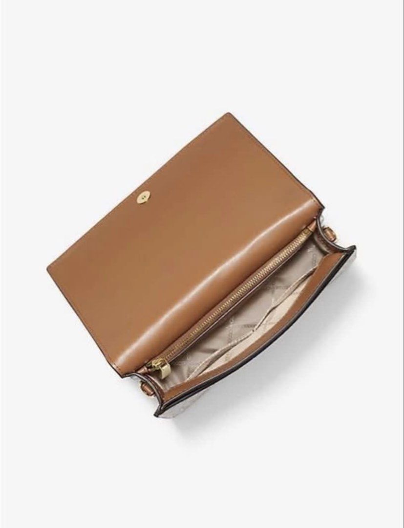 Michael Kors MK Logo Crossbody Bag (Category: Cross-body Bags) located in Lapu Lapu. Submitted by happyfox_d8cb2d (Listing ID 1466419528, Image 3). Description: Michael Kors crossbody bag in signature vanilla and acorn brown monogram canvas. Tan leather trim, gold-tone hardware. Front flap closure with magnetic snap. Adjustable buckle shoulder strap with chain link details. Inside has a zip pocket and slip pocket. Neutral colorway matches everyth