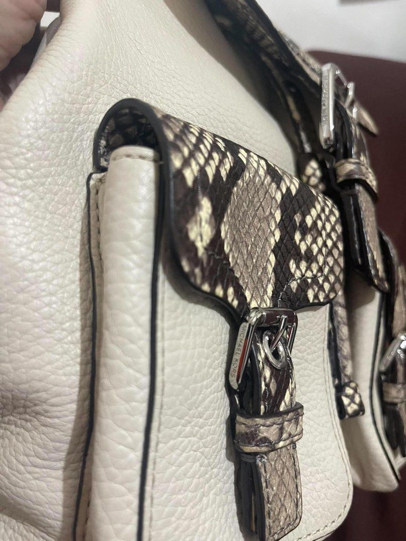Michael Kors Python Print Leather Backpack (Category: Backpacks) located in Quezon City. Submitted by pickleballpaddle (Listing ID 1466440953, Image 2). Description: - Brand: Michael Kors - Material: Cream pebble leather with faux snakeskin print - Color: Cream and grey tones - Closure: Flap top with secure buckle detail - Exterior: Handy front pockets and sturdy top handle - Straps: Adjustable back straps for comfort - Interior: Signature Michae
