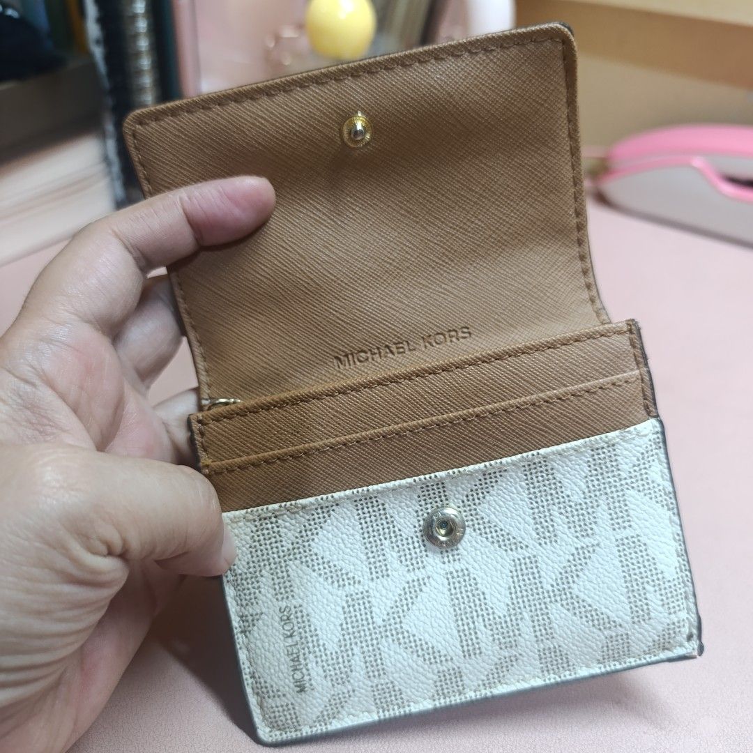 Michael Kors Two-Tone Card Case Wallet (Category: Wallets & Card holders) located in Las Pinas. Submitted by min_yanna (Listing ID 1466482592, Image 3). Description: Great condition preloved authentic Michael Kors small wallet in brown and white monogram print. Gold hardware, snap closure. Front flap opens up with card slots and inner compartment. Back side has a clear ID window and a zippered coin pocket with a branded zipper pull. Attached key 