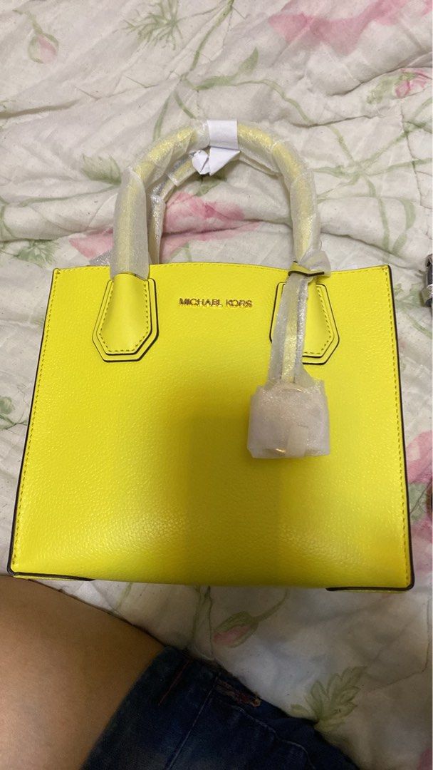 Michael Kors yellow tote handbag (Category: Tote Bags) located in Pasig City. Submitted by raine.lb (Listing ID 1466408941, Image 1). Description: - Authentic Michael Kors leather tote in a stunning bright yellow shade - Elegant gold-tone hardware and signature lettering - Structured silhouette with a flat bottom for easy storage and stability - Clean, chic design ideal for work, travel, or casual days out.