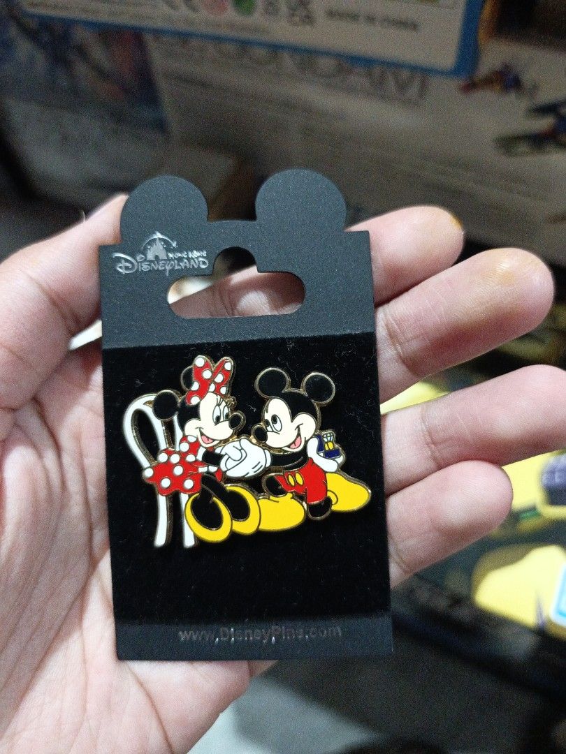 Mickey and Minnie Engagement Pin (Category: Vintage Collectibles) located in Marikina City. Submitted by eminachii (Listing ID 1466484602, Image 2). Description: a classic Vintage open-edition Disney enamel pin featuring Mickey Mouse proposing to Minnie Mouse Design: Mickey Mouse is kneeling in red shorts and yellow shoes/bow tie, holding a ring box out toward Minnie Mouse, who is seated on a white chair wearing a red-and-white polka dot dress an