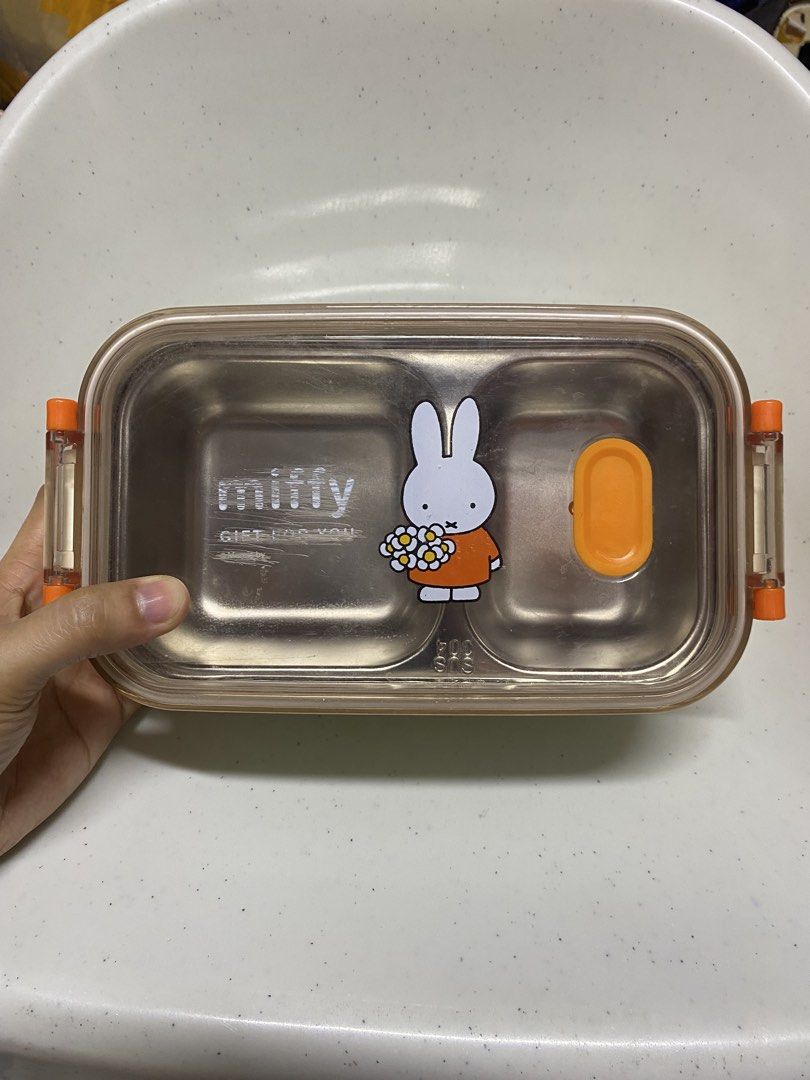 Miffy Double-Layer Stainless Steel Lunch Box (Category: Food Organization & Storage) located in Pasacao. Submitted by wengpullar37205 (Listing ID 1466414120, Image 3). Description: - Authentic Miffy double-layer lunch box featuring an adorable floral graphic on a clear lid - Made with safe and durable SUS304 stainless steel inner compartments - Stackable design keeps your rice and dishes neatly separated - Equipped with secure orange side latches