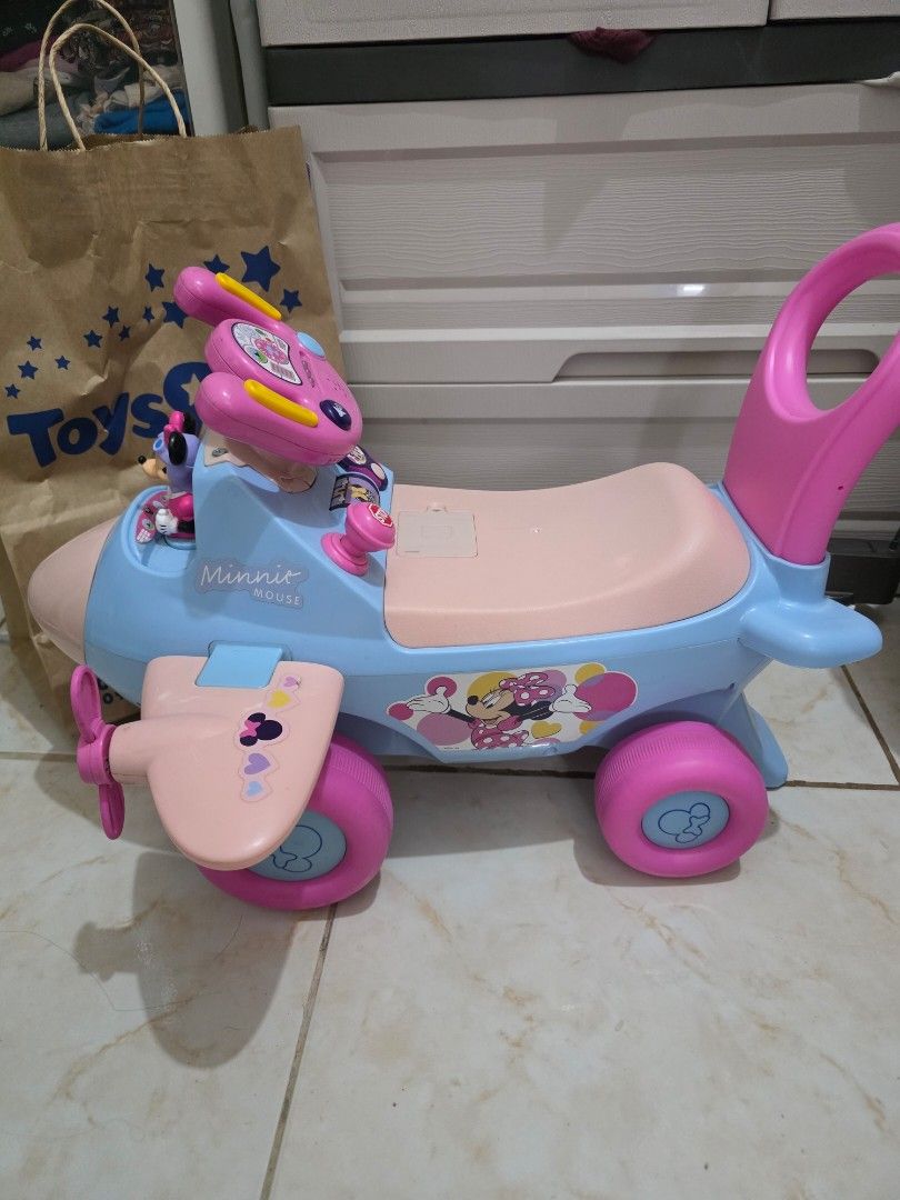 Minnie Mouse Ride-On Airplane Toy (Category: Kids Toys) located in Taguig. Submitted by jeaniper (Listing ID 1466363081, Image 2). Description: - Minnie Mouse toddler ride-on airplane in blue and pink - Features interactive buttons on the steering wheel and a built-in Minnie figure - Equipped with sturdy large pink wheels and a convenient push handle at the back - Perfect toy for toddlers to scoot around and play - Condition: Normal signs of use 