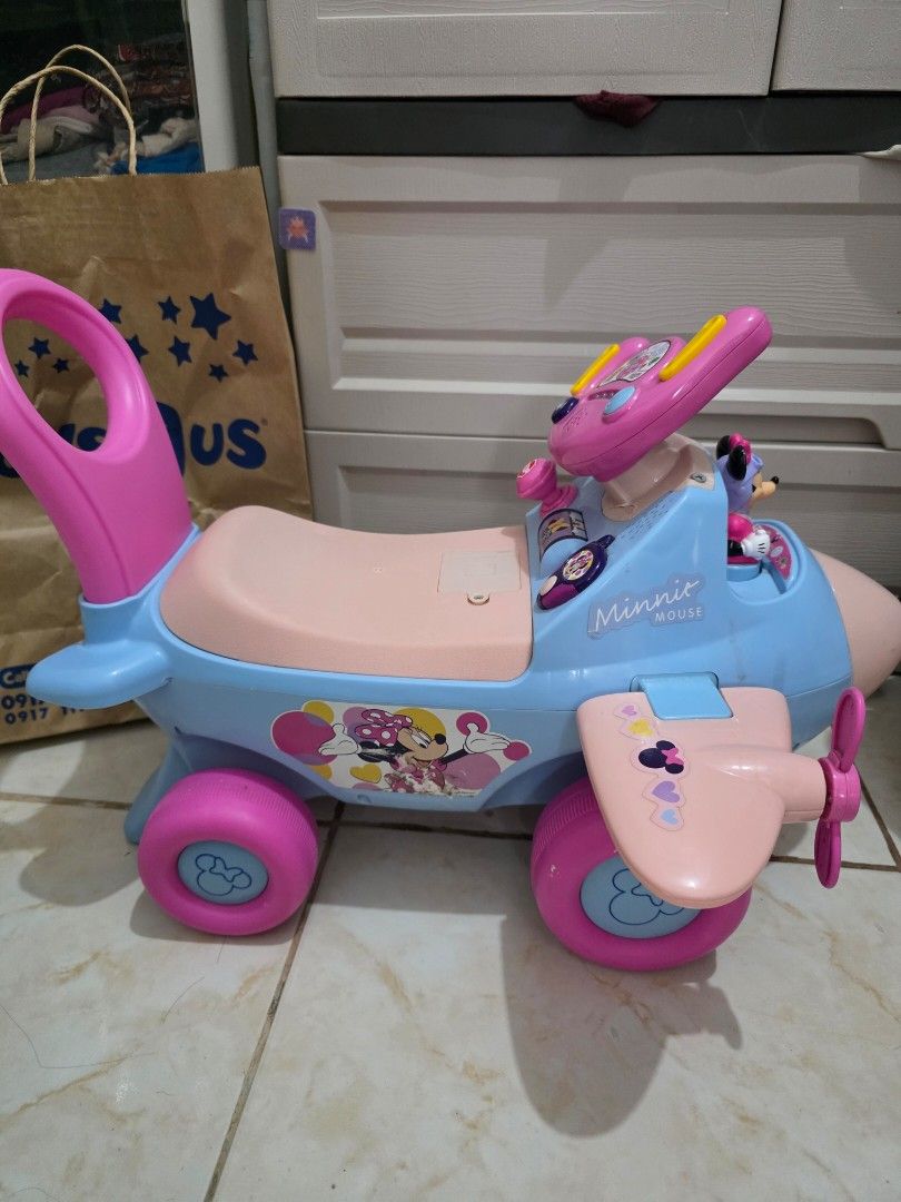 Minnie Mouse Ride-On Airplane Toy (Category: Kids Toys) located in Taguig. Submitted by jeaniper (Listing ID 1466363081, Image 3). Description: - Minnie Mouse toddler ride-on airplane in blue and pink - Features interactive buttons on the steering wheel and a built-in Minnie figure - Equipped with sturdy large pink wheels and a convenient push handle at the back - Perfect toy for toddlers to scoot around and play - Condition: Normal signs of use 