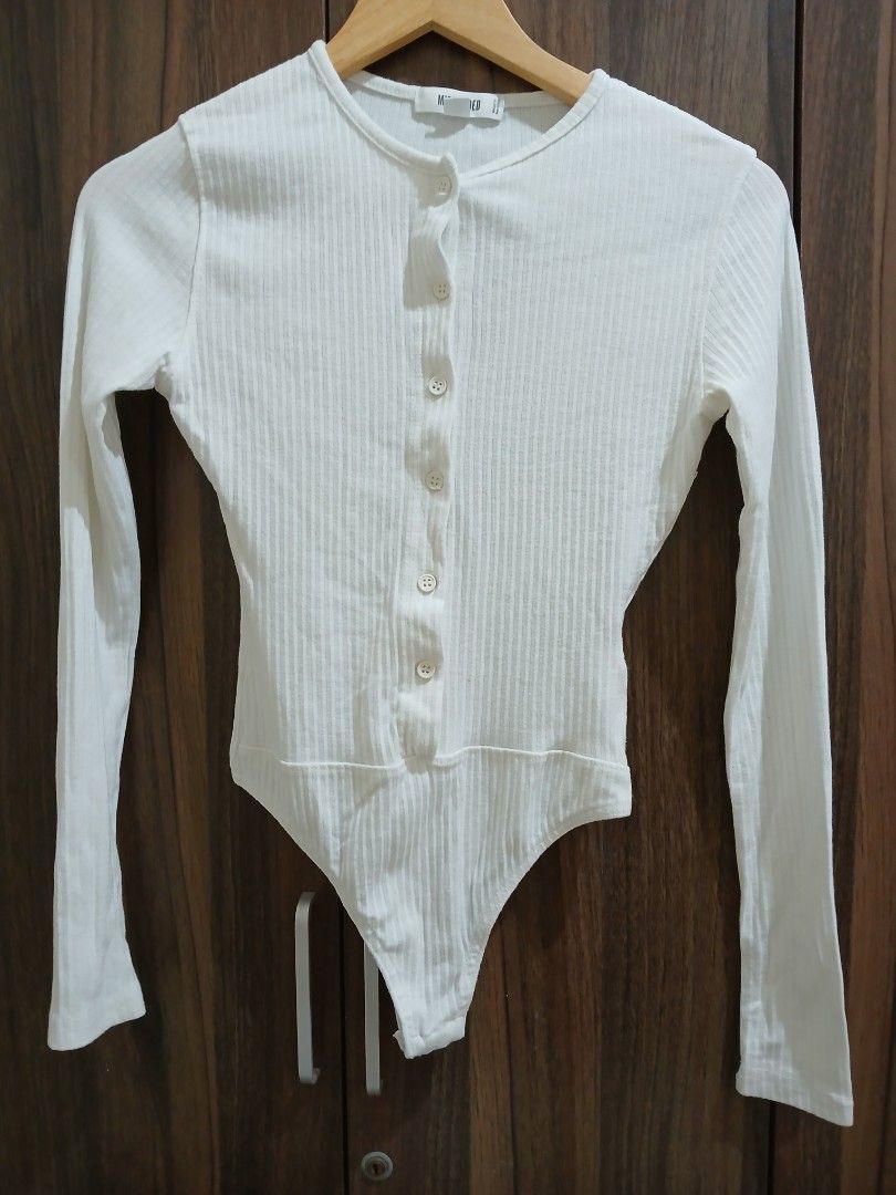 Missguided White Ribbed Long Sleeve Button Up Bodysuit (Category: Longsleeves) located in Manila. Submitted by relaxlang (Listing ID 1466398920, Image 1). Description: - Brand: Missguided - Style: Ribbed long-sleeve bodysuit with crew neckline and front button placket - Color: White - Size: UK 8 / EUR 36 / US 4 - Closure: Bottom snap buttons for easy wear - Origin: Made in Pakistan - Condition: Excellent.