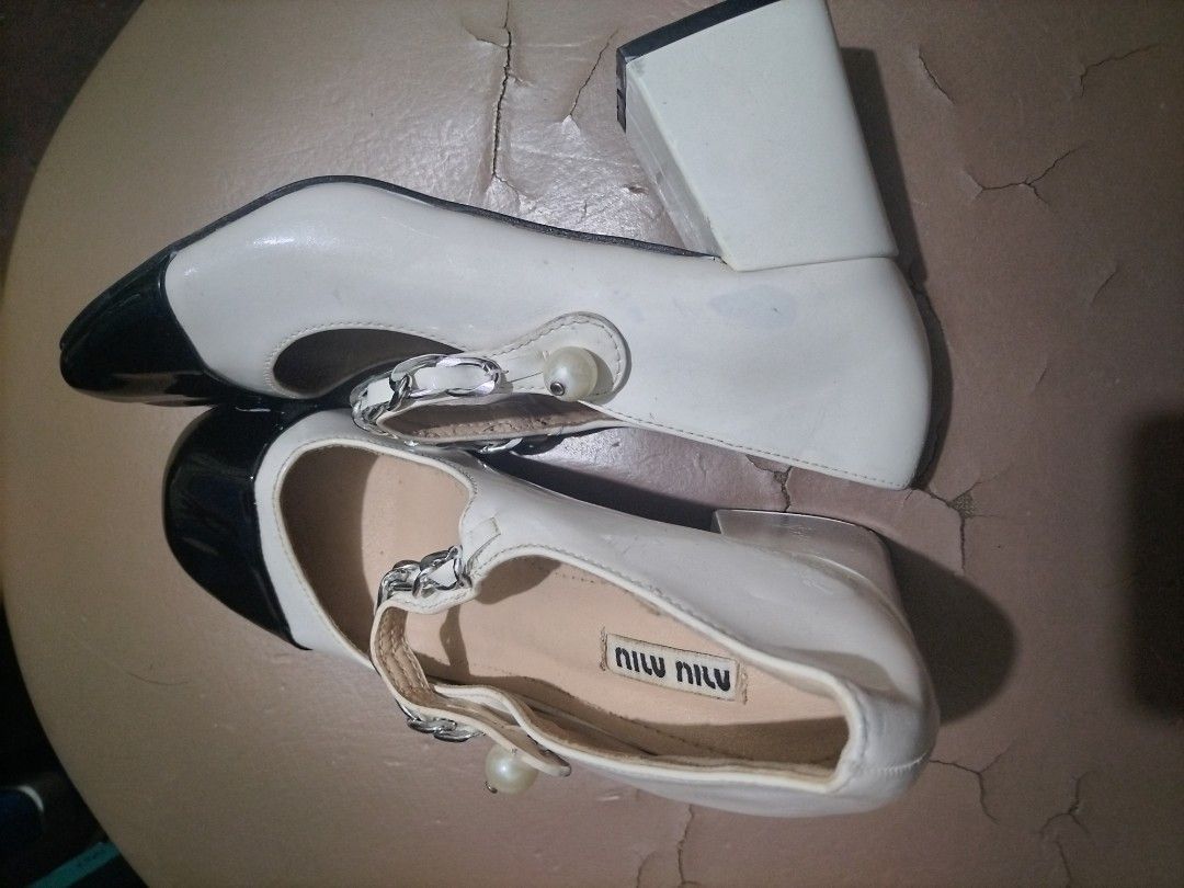 miu miu mary jane cap toe pumps (Category: Sneakers & Footwear) located in Valenzuela. Submitted by nurzdara28 (Listing ID 1466511729, Image 2). Description: These Mary Jane pumps are crafted in patent leather with a contrast leather cap toe that accentuates the round toe shape. The feminine style features a pearl button and silver-tone chain adorning the strap across the instep. Made in Italy, they are set on a sturdy, covered block heel for eve