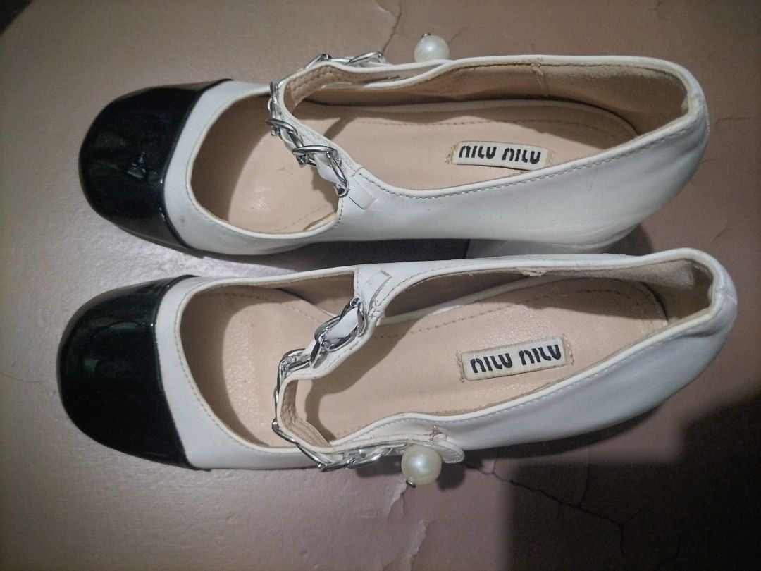 miu miu mary jane cap toe pumps (Category: Sneakers & Footwear) located in Valenzuela. Submitted by nurzdara28 (Listing ID 1466511729, Image 1). Description: These Mary Jane pumps are crafted in patent leather with a contrast leather cap toe that accentuates the round toe shape. The feminine style features a pearl button and silver-tone chain adorning the strap across the instep. Made in Italy, they are set on a sturdy, covered block heel for eve