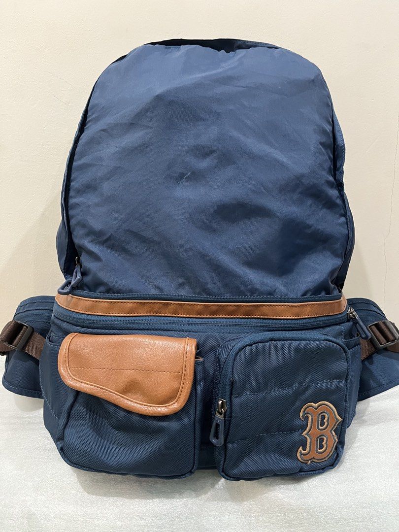 MLB Boston Red Sox Blue Backpack (Category: Backpacks) located in Talisay. Submitted by cherylu (Listing ID 1466504317, Image 1). Description: - Color: Navy blue with brown straps and faux leather trim - Team: Official Boston Red Sox 'B' embroidered patch - Storage: Multiple zippered compartments and pockets for easy organization - Comfort: Adjustable brown shoulder straps with secure plastic buckle closure - Details: Custom MLB-branded zipper pu