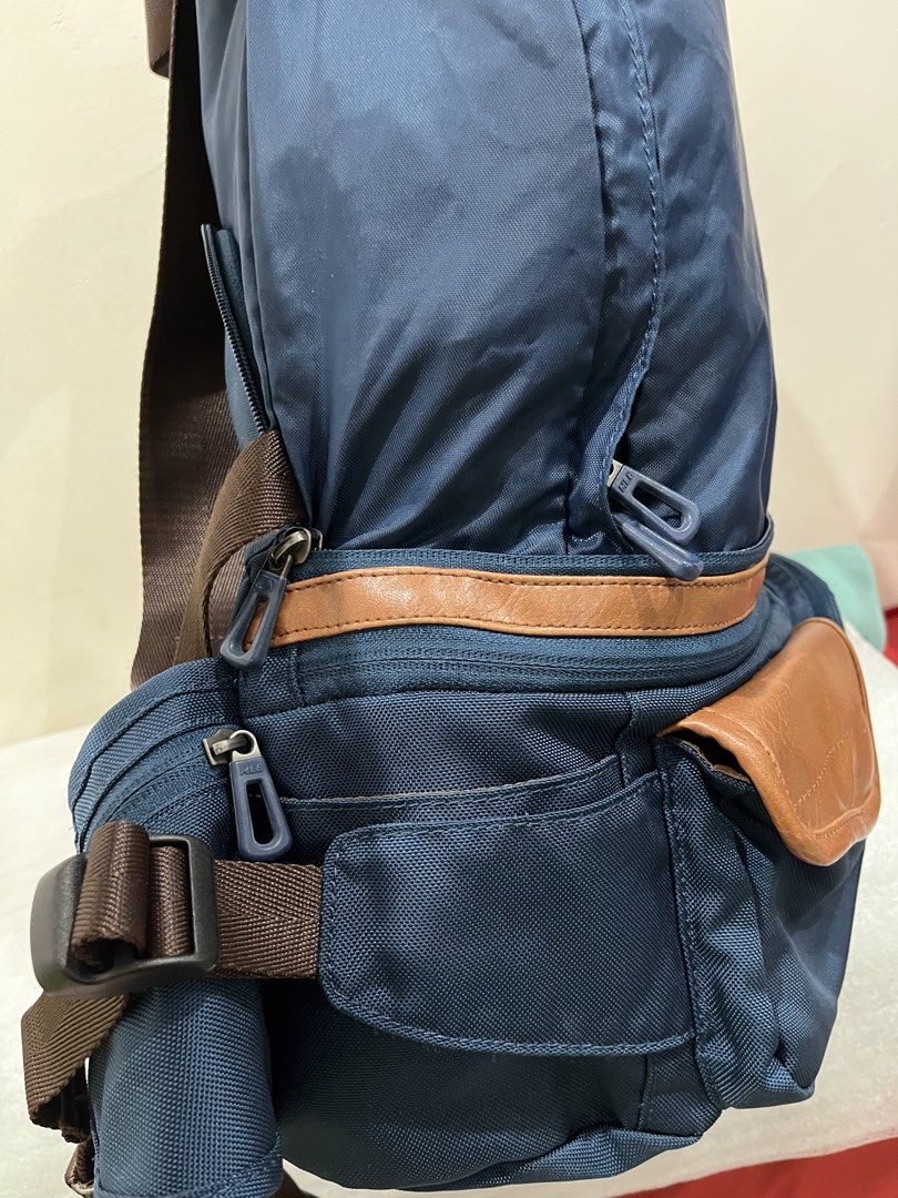 MLB Boston Red Sox Blue Backpack (Category: Backpacks) located in Talisay. Submitted by cherylu (Listing ID 1466504317, Image 3). Description: - Color: Navy blue with brown straps and faux leather trim - Team: Official Boston Red Sox 'B' embroidered patch - Storage: Multiple zippered compartments and pockets for easy organization - Comfort: Adjustable brown shoulder straps with secure plastic buckle closure - Details: Custom MLB-branded zipper pu