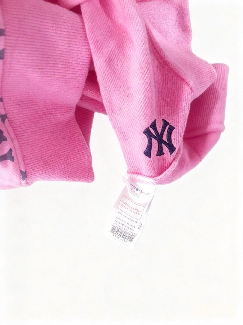 MLB New York Yankees Monogram Pink Sweatshirt (Category: Coats, Jackets and Outerwear) located in Manila. Submitted by nisayy13 (Listing ID 1466441328, Image 3). Description: MLB New York Yankees pink sweatshirt with all-over NY monogram print. Features embroidered Yankees logo patch on the chest and MLB branding on the collar and sleeve tag. Long sleeves, ribbed cuffs and hem. Comfortable cotton blend fabric, vibrant pink shade with dark navy pr
