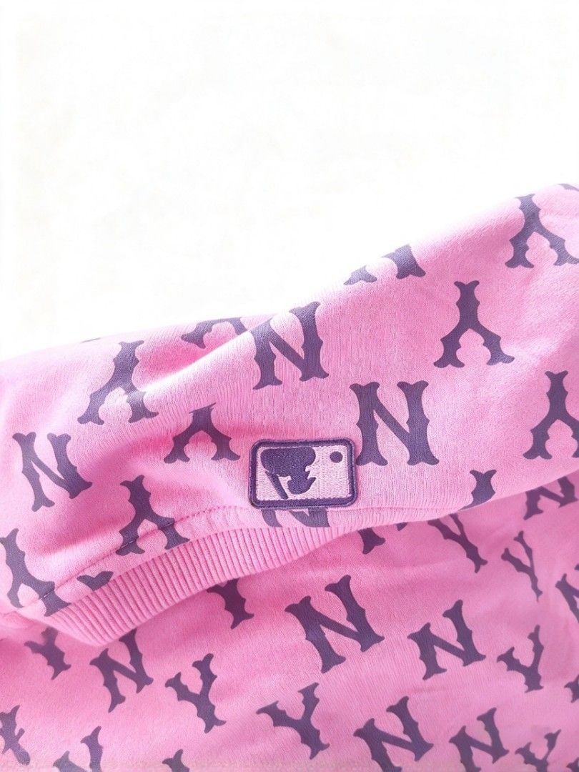 MLB New York Yankees Monogram Pink Sweatshirt (Category: Coats, Jackets and Outerwear) located in Manila. Submitted by nisayy13 (Listing ID 1466441328, Image 2). Description: MLB New York Yankees pink sweatshirt with all-over NY monogram print. Features embroidered Yankees logo patch on the chest and MLB branding on the collar and sleeve tag. Long sleeves, ribbed cuffs and hem. Comfortable cotton blend fabric, vibrant pink shade with dark navy pr