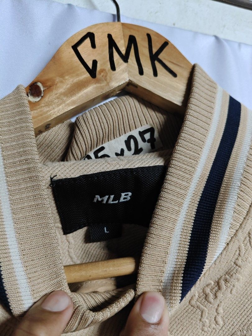 MLB yankees (Category: Coats, Jackets and Outerwear) located in Rizal. Submitted by itsmecle0 (Listing ID 1466404204, Image 3). Description: This stylish garment is an MLB New York Yankees Classic Monogram Bomber/Varsity Jacket. It features a tan/khaki fleece-like or textured fabrication covered in an all-over embossed or jacquard "NY" monogram pattern, accented by the iconic New York Yankees logo embroidered on the left chest and classic striped