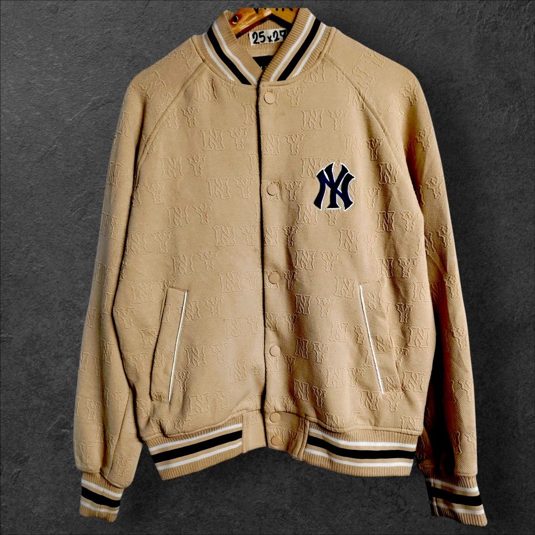 MLB yankees (Category: Coats, Jackets and Outerwear) located in Rizal. Submitted by itsmecle0 (Listing ID 1466404204, Image 1). Description: This stylish garment is an MLB New York Yankees Classic Monogram Bomber/Varsity Jacket. It features a tan/khaki fleece-like or textured fabrication covered in an all-over embossed or jacquard "NY" monogram pattern, accented by the iconic New York Yankees logo embroidered on the left chest and classic striped