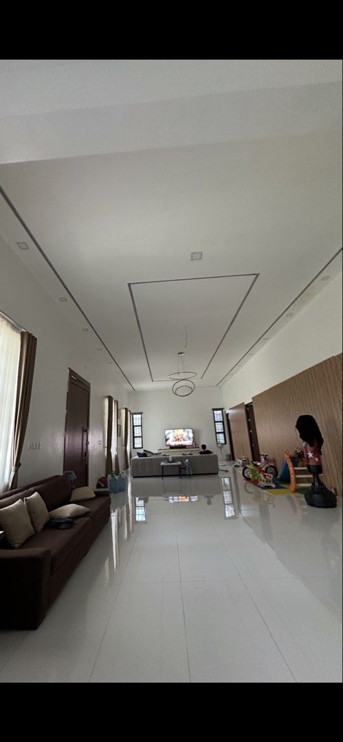Modern 3 Storey House Interior and Exterior (Category: House & Lot) located in Angeles City. Submitted by rechell1969 (Listing ID 1466420413, Image 2). Description: Spacious 3- storey home with a neat outdoor porch setup and lush plants. Inside has a long open layout combining the living area and kitchen. Kitchen features a long marble-top island with wooden accents. Bedrooms have tiled floors, air conditioning, and plenty of room. Bathrooms have