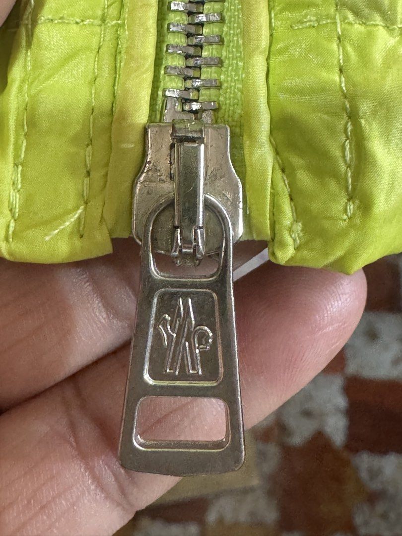 Moncler 100% Original (Category: Luxury Apparel) located in Manila. Submitted by wildbear.e10374 (Listing ID 1466411715, Image 3). Description: - Authentic Moncler neon yellow windbreaker jacket - Size: 4 (tag attached) - Features a built-in hood and full front zipper with branded logo hardware - Iconic tricolor badge patch on the chest - Lightweight and easily packable design - Interior care labels fully intact - Made in Italy.