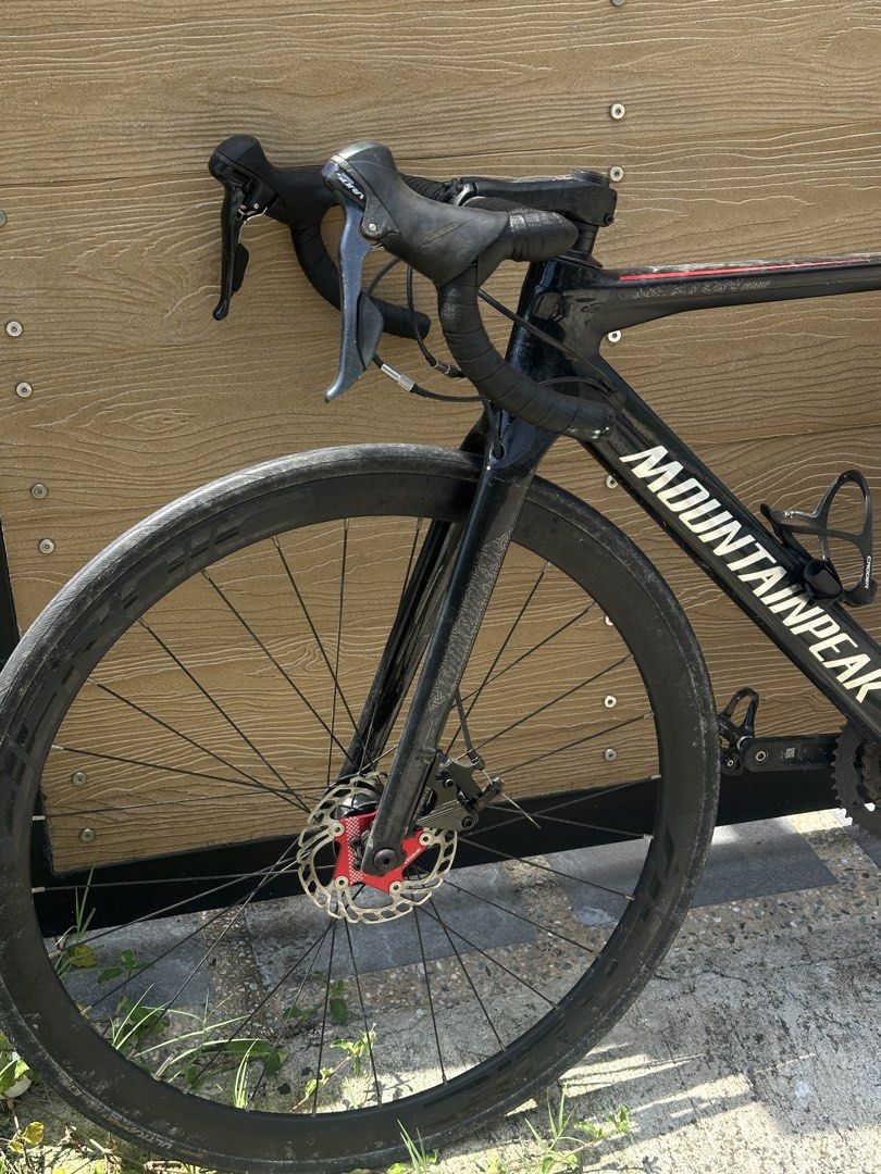 Mountainpeak Black Road Bike (Category: Bicycles) located in Mandaluyong City. Submitted by dhanlumanas (Listing ID 1466455065, Image 3). Description: Mountainpeak road bike in black. Deep section wheels, drop handlebars, disc brakes with red accents. Includes a water bottle holder and a bottle. Black saddle with slight scuffs on the seat post. Great option for road riding or commuting. Grab it before it's gone..