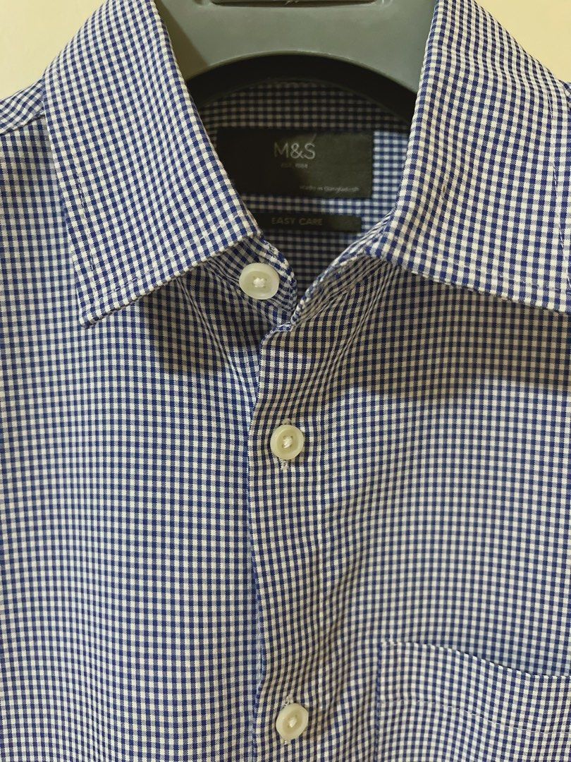 M&S Blue Gingham Short Sleeve Shirt Size S (Category: Tshirts & Polo Shirts ) located in Manila. Submitted by _preciousfinds.2 (Listing ID 1466516650, Image 3). Description: - Brand: Marks & Spencer (M&S) - Design: Blue and white gingham check pattern - Size: S - Features: Short sleeves, classic button-down front, single chest pocket - Material: Easy-care fabric.
