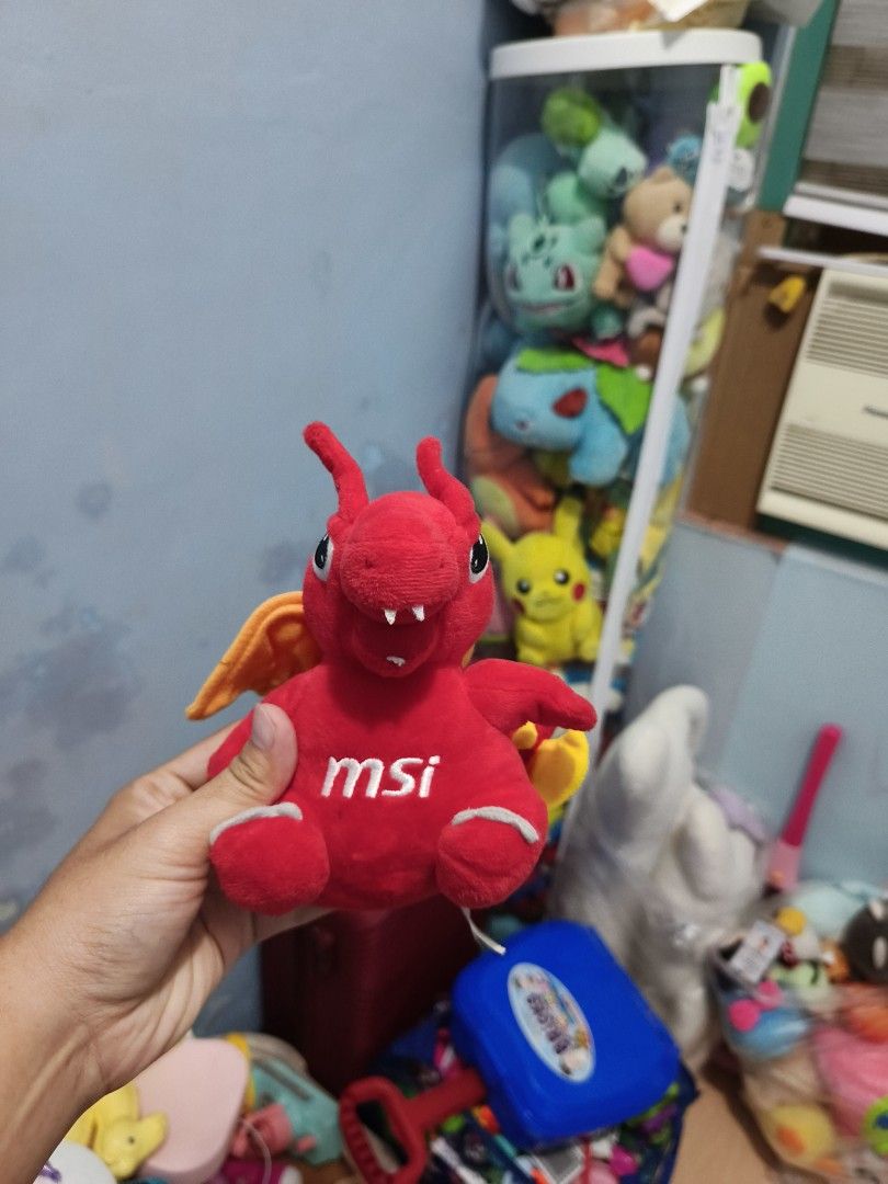 MSI Lucky the Dragon plush toy (Category: Plushies & Soft Toys) located in Iligan City. Submitted by sneakymagician (Listing ID 1466479674, Image 1). Description: - Adorable red MSI dragon plush toy - Features vibrant orange wings and yellow back spikes - White MSI logo neatly embroidered on the chest - Cute small antennae on the head - Clean fabric with a very soft texture.