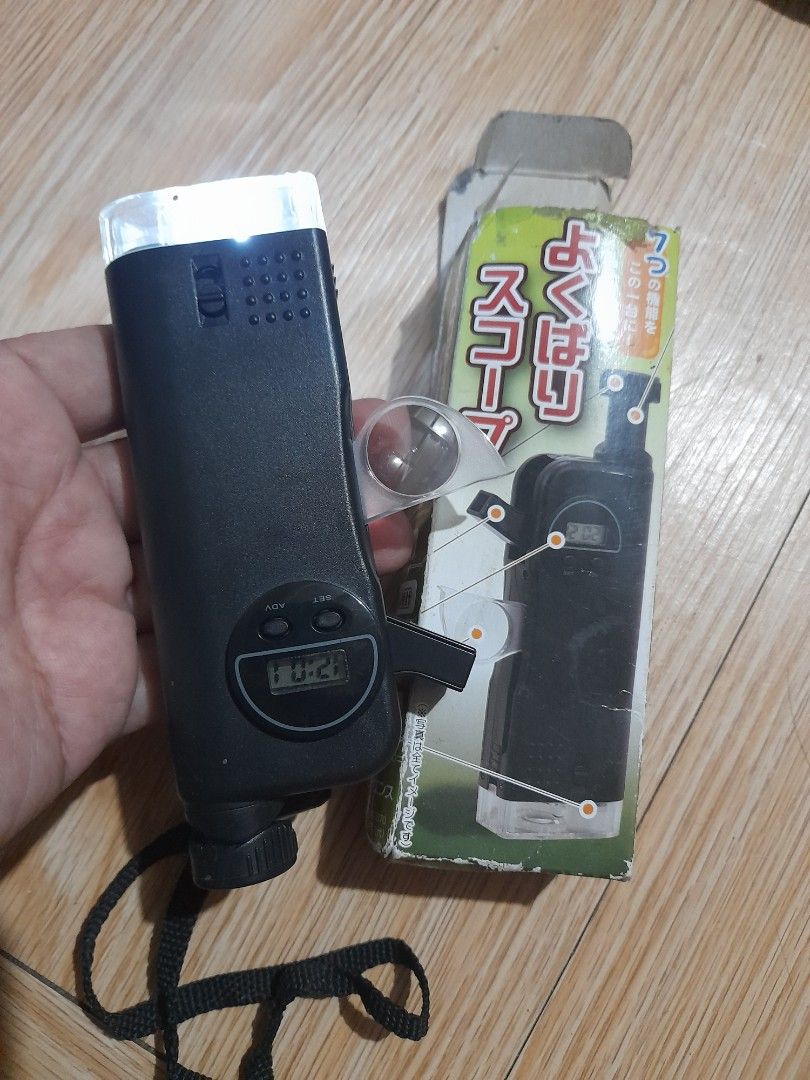 Multifunctional 7-in-1 Outdoor Scope with Compass and LED Light (Category: Hiking & Camping) located in Bocaue. Submitted by marajapansurplus (Listing ID 1466478992, Image 1). Description: - Multi-tool outdoor gadget for hiking, camping, and adventures - Functions include: digital clock, working compass, flashlight, extendable monocular scope, magnifying glass, and whistle - Compact black plastic body equipped with a convenient hand strap - Comes